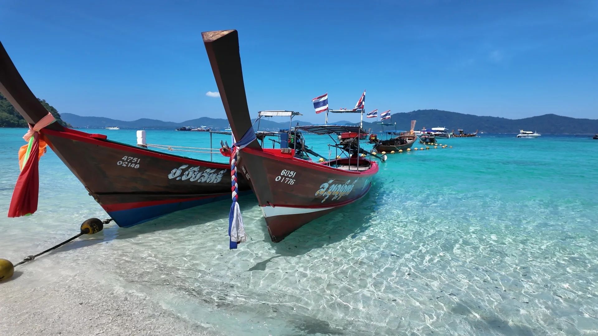A longtail or speedboat on a calm sea. This is the boat day you are protecting when you match the month to the coast. Andaman boats want roughly November to April. Gulf boats are often better from January to September
