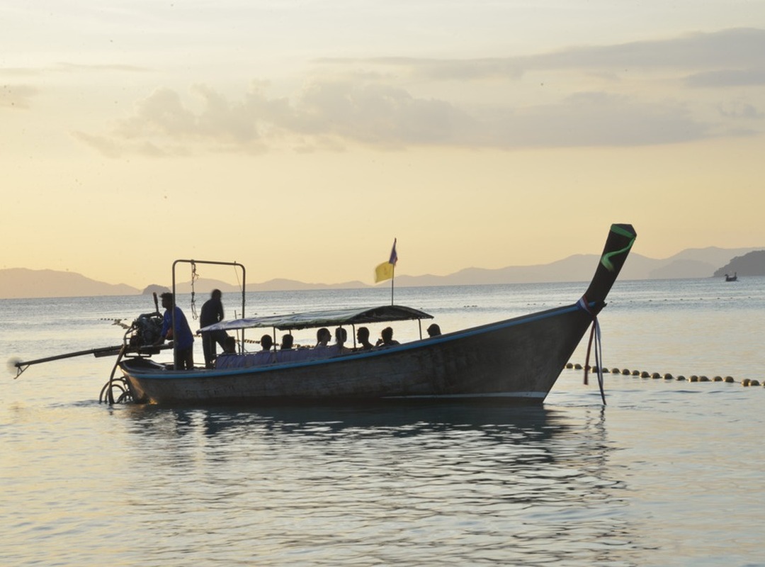 December Andaman evenings — calm water and classic long-tail boat light.